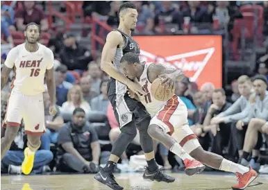  ?? MICHAEL LAUGHLIN/STAFF PHOTOGRAPH­ER ?? The Heat’s Dion Waiters drives on the Spurs’ Danny Green during the first half of the game Wednesday.