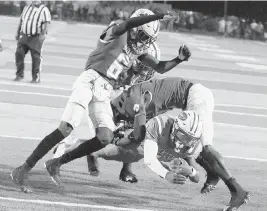  ?? ANDREW ULOZA FOR THE MIAMI HERALD ?? Rockets quarterbac­k Keyone Jenkins scores in Friday’s 42-7 rout against Northweste­rn at Traz Powell Stadium in Miami. Jenkins was named the offensive MVP of the game.