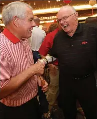  ?? NWA Democrat-Gazette/ANDY SHUPE ?? Ken Hatfield (left), who led the Razorbacks to a 55-17-1 record as their head coach from 1984-89, shares a laugh with Jesse Branch during the annual kickoff luncheon on Friday at the Northwest Arkansas Convention Center in Springdale. Hatfield said he liked what he heard from Coach Chad Morris at the luncheon.