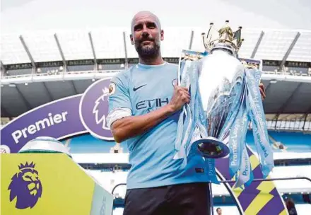  ?? REUTERS PIC ?? Manchester City manager Pep Guardiola with the English Premier League trophy on Sunday.