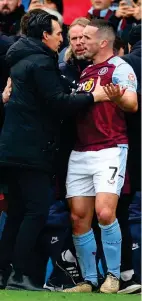  ?? GETTY IMAGES ?? Calm down: Emery restrains McGinn after his red