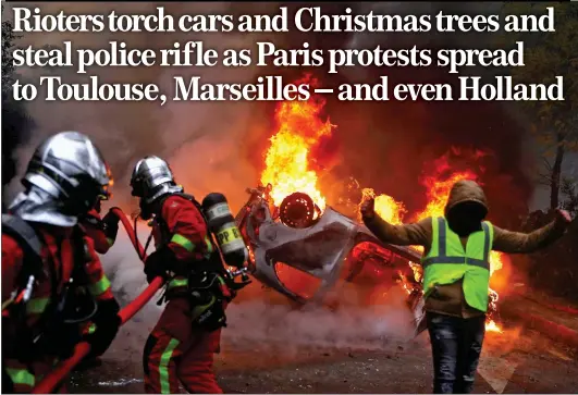  ??  ?? CLASHES: Firefighte­rs tackle a burning car in the Champs-Elysées, and above left, yellow vest protesters set fire to barricades near the Arc de Triomphe