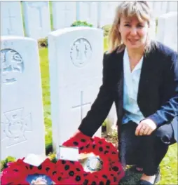  ??  ?? Sue Cotter laying flowers at the grave of her great uncle in France – VC hero William Cotter