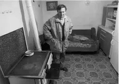  ?? Darko Vojinovic/ the associated press ?? Radoslav Stekic in the room where his mother Danica was shot to death while sleeping in the village of Velika Ivanca, Serbia.