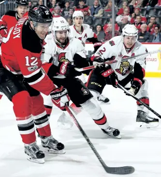  ?? ELSA/GETTY ?? Ben Lovejoy of the New Jersey Devils heads for the net as Tom Pyatt and Dion Phaneuf of the Ottawa Senators defend on Thursday at Prudential Center in Newark, N.J.