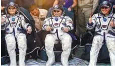  ??  ?? Back to earth ... (from left) Whitson, Fischer, and Yurchikhin meeting the press after they landed.