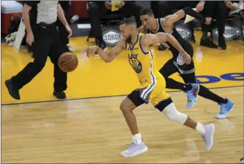  ?? AP PHOTO/TONY AVELAR ?? Golden State Warriors guard Stephen Curry (30) steals the ball from Sacramento Kings guard Tyrese Haliburton (0) during the first half of an NBA basketball game on Sunday in San Francisco.