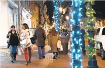  ?? BRIAN KRISTA/CAPITAL GAZETTE ?? People walk along Main Street during Midnight Madness in Annapolis in 2020. This year’s event begins Thursday.