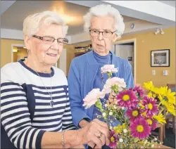  ?? JEREMY FRASER/CAPE BRETON POST ?? Mamie Johnstone, left, and Yvonne Johnstone look at a flower bouquet on Tuesday. The sisters-in-law are the longest serving members of the North Sydney Garden Club, which will kick off its 60th anniversar­y with an open house on Saturday at the Cape...