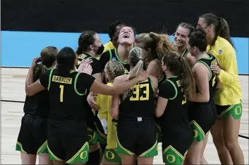  ?? ERIC GAY — THE ASSOCIATED PRESS ?? Forward Sedona Prince, center, celebrates with teammates after Oregon defeated Georgia in a second-round game of the NCAA Tournament at the Alamodome in San Antonio on Wednesday. Oregon won 57-50.