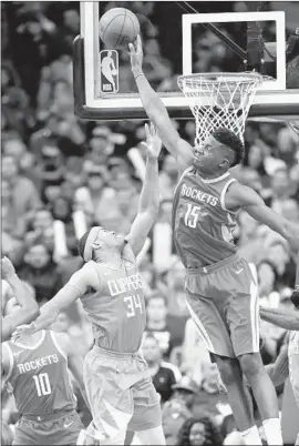  ?? David J. Phillip Associated Press ?? HOUSTON’S CLINT CAPELA blocks a shot by the Clippers’ Tobias Harris during the second half of the Rockets’ 101-96 home victory.