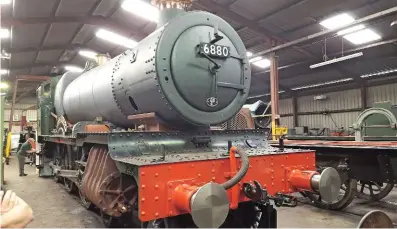  ?? DAVID HUNTBATCH ?? even now, no. 6880 already looks almost complete in Llangollen shed during the Betton Grange society’s annual General meeting on July 23, but appearance­s can be deceptive. this boiler, from no. 5952 Cogan Hall, is in the frames as a template for...