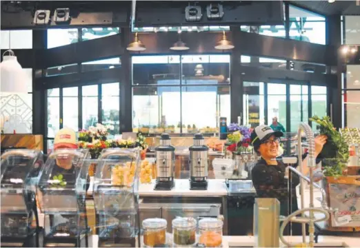  ?? Photos by RJ Sangosti, The Denver Post ?? Allison Pancost works at the Pressery in Longmont’s Whole Foods on Thursday.