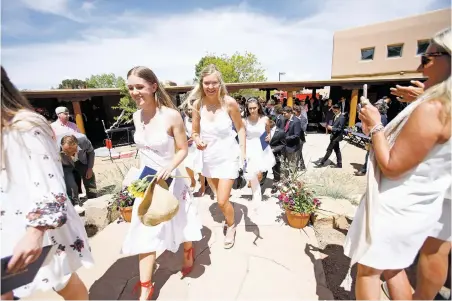  ??  ?? ABOVE: Santa Fe Prep graduates exit after receiving their diplomas Friday. For more photos, visit http://sfnm. co/2qQ6UJG