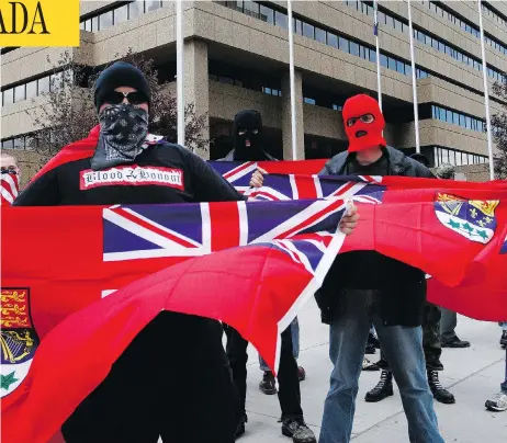  ?? ADRIAN SHELLARD/POSTMEDIA NEWS ?? Members of the Aryan Guard display the Red Ensign during a speech by notorious white nationalis­t Paul Fromm in downtown Calgary in 2008.
