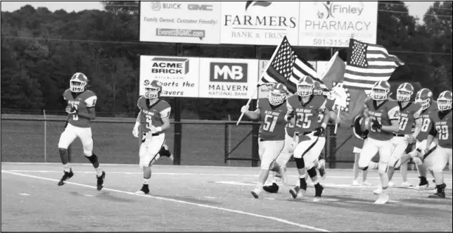  ??  ?? Photo by Alexis Meeks The Glen Rose Beavers run onto the field at Beaver Stadium for a recent game. The Beavers will be without 10 starters Friday as they host West Fork in the second round of the 3A State Playoffs.