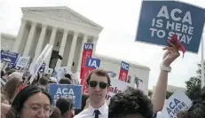  ?? Mark Wilson/Getty Images ?? People celebrate at the U.S. Supreme Court in Washington Thursday after the court upheld the Affordable Care Act.