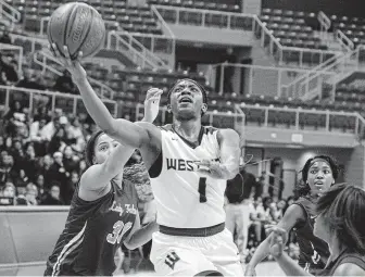  ?? Craig Moseley / Staff photograph­er ?? Kayla Pilson (1) of Westside, who finished with 20 points, drives to the basket during the playoff game between Westside and Jersey Village on Tuesday night at the Merrell Center in Katy.