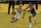  ?? JEFF CHIU — THE ASSOCIATED PRESS ?? Golden State Warriors forward Alen Smailagic dribbles against Denver Nuggets forward Zeke Nnaji during a preseason game Saturday in San Francisco.