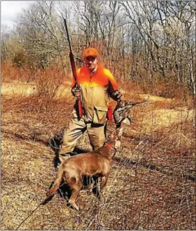  ?? TOM TATUM - FOR DIGITAL FIRST MEDIA ?? Kennett’s Ron Dickens accepts a pheasant retrieve from Grace, a silver Labrador Retriever, at the Powderbour­ne Hunting Preserve in Montgomery County.