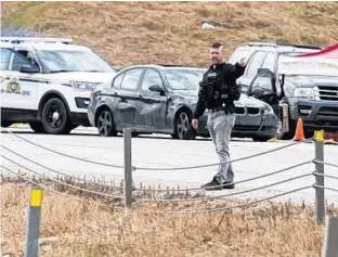  ?? POSTMEDIA NEWS ?? Police officers work at the scene of a shooting involving a police officer along the QEII just north of the Hwy 2A exit, in Leduc, Alta. on Wednesday.