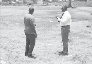  ??  ?? Guyana Football Federation president Wayne Forde, right, inspects the site for the proposed erection of a regional football facility in New Amsterdam.