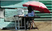  ??  ?? A MAN sewing masks outside his home in the informal settlement of Wallaceden­e, Kraaifonte­in.