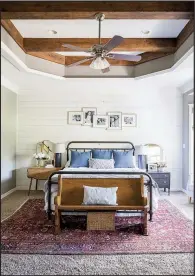  ?? AP/Grace Laird Photograph­y/Moore House Interiors ?? For this master bedroom, designer Ashley Moore layered a patterned rug over neutral wall-to-wall carpeting to add a layer of warmth and color.