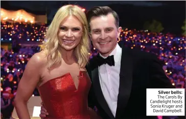  ??  ?? Silver bells: The Carols By Candleligh­t hosts Sonia Kruger and David Campbell.