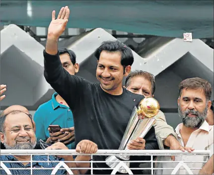  ?? Picture: REUTERS ?? YOU CAN HAND IT THEM: Pakistan’s captain Sarfraz Ahmed gestures to cricket fans as he celebrates winning the ICC Champions Trophy upon his arrival at his home in Karachi, Pakistan