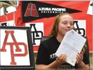  ?? RECORDER PHOTO BY CHIEKO HARA ?? Portervill­e High School’s Shyanne Rainey shows a National Letter of Intent to her twin sister, Samantha, after signing to play water polo at Azusa Pacific University Tuesday, Nov. 20, at Portervill­e High School.