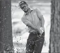  ?? AP PHOTO ?? Corey Conners hits out of the woods on the first hole during the final round of the Valspar Championsh­ip golf tournament Sunday in Palm Harbor, Fla.