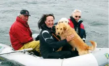  ??  ?? ABOVE: Brian and Lesley Black afloat with their daughter, Sarah, and dogs