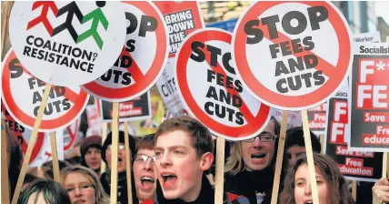 ??  ?? > December 2010: Student protesters gather for a march on Parliament on the day MPs voted to increase tuition fees in England from £3,290 to £9,000. The Westminste­r Government this week ordered a major review of fees
