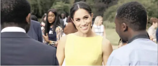  ??  ?? Meghan, Duchess of Sussex, at Marlboroug­h House in London meeting young people from the Commonweal­th. A new two-part ITV series offers a unique insight into the queen’s role and the baton she is passing to the younger members of the royal family.