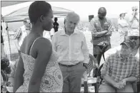  ?? AP/JUSTIN LYNCH ?? U.S. Sens. Bob Corker (center), R-Tenn., and Chris Coons (right), D-Del., speak with a South Sudanese refugee during a group discussion Friday at the Bidi Bidi refugee settlement in northern Uganda.