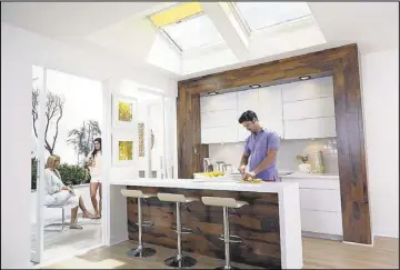  ??  ?? Energy Star-qualified solar powered fresh air skylights provide balanced natural light and passive ventilatio­n in your home while providing decorating flare. Solar powered fresh air skylights and blinds, which are operated by remote control, are...