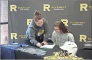  ?? / Kevin Myrick ?? Reinhardt coach Jade Geuther showed Emily Loveless where to sign on the dotted line to attend school as a Lady Eagle starting in 2019.