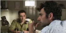  ??  ?? WRITER’S BLOCK: Salam (Kais Nashif), right, consults on a script with commander Assi (Yaniv Biton) in ‘Tel Aviv on Fire.’