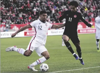  ?? NATHAN DENETTE/THE CANADIAN PRESS VIA AP ?? Canada’s Tajon Buchanan (right) pressures United States’ Miles Robinson during the first half of a World Cup soccer qualifier in Hamilton, Ontario, on Jan. 30.
