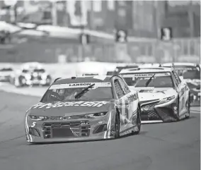  ?? MATT KELLEY/AP ?? Kyle Larson leads the pack of cars during a NASCAR Cup Series race Sunday at Charlotte Motor Speedway.