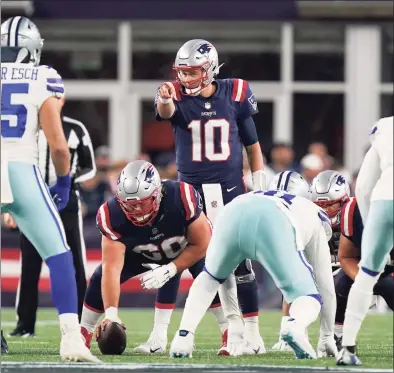  ?? Steven Senne / Associated Press ?? New England Patriots quarterbac­k Mac Jones signals from the line during the second half against the Dallas Cowboys last Sunday.