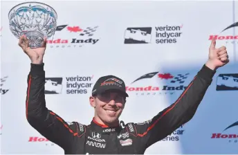  ?? CITIZEN NEWS SERVICE PHOTO BY FRANK GUNN ?? Robert Wickens celebrates his third place finish at the Honda Indy in Toronto on Sunday, July 15, 2018. Wickens crashed Sunday, August 19 at the Pocono Raceway and was seriously injured.