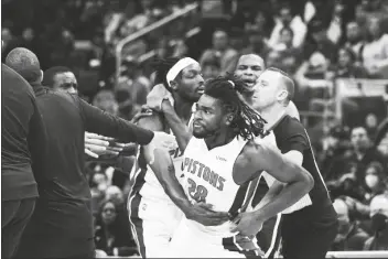  ?? CARLOS OSORIO/AP ?? DETROIT PISTONS CENTER ISAIAH STEWART (28) is held back after a foul during the second half of a game against the Los Angeles Lakers on Sunday in Detroit.