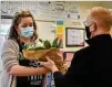  ??  ?? Cherokee County School District Teacher of the Year finalist Chelsea Leming of Indian Knoll Elementary accepts flowers from Superinten­dent of Schools Brian V. Hightower.