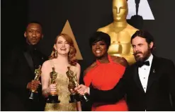  ??  ?? Best Supporting Actor Mahershala Ali, Best Actress Emma Stone, Best Supporting Actress Viola Davis and Best Actor Casey Affleck pose in the press room during the 89th Oscars.