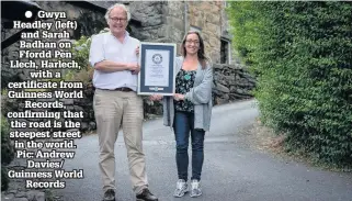  ??  ?? ● Gwyn Headley (left) and Sarah Badhan on Ffordd Pen Llech, Harlech, with a certificat­e from Guinness World Records, confirming that the road is the steepest street in the world. Pic: Andrew Davies/ Guinness World Records