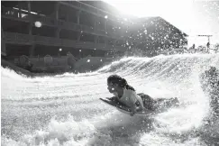  ?? Associated Press ?? ■ Elle Garcia, 14, learns to surf at Schlitterb­ahn Corpus Christi on Tuesday in Corpus Christi, Texas.