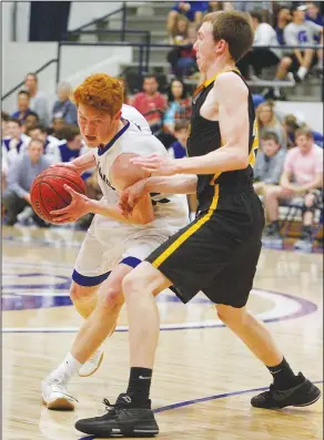  ?? Terrance Armstard/News-Times ?? Room to move: Parkers Chapel's Dawson Goodwin (4) tries to drive the ball around Harmony Grove's Johnny Pierce (24) during their contest at the 7-2A East District Tournament Thursday. The Trojans advanced to the finals with a 60-52 win.