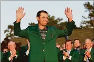  ?? David J. Phillip / Associated Press ?? Scottie Scheffler celebrates after putting on the green jacket after winning the Masters on April 10 in Augusta, Ga. Scheffler goes after the second leg of Grand Slam when he plays the PGA Championsh­ip next week at Southern Hills in Tulsa, Okla.